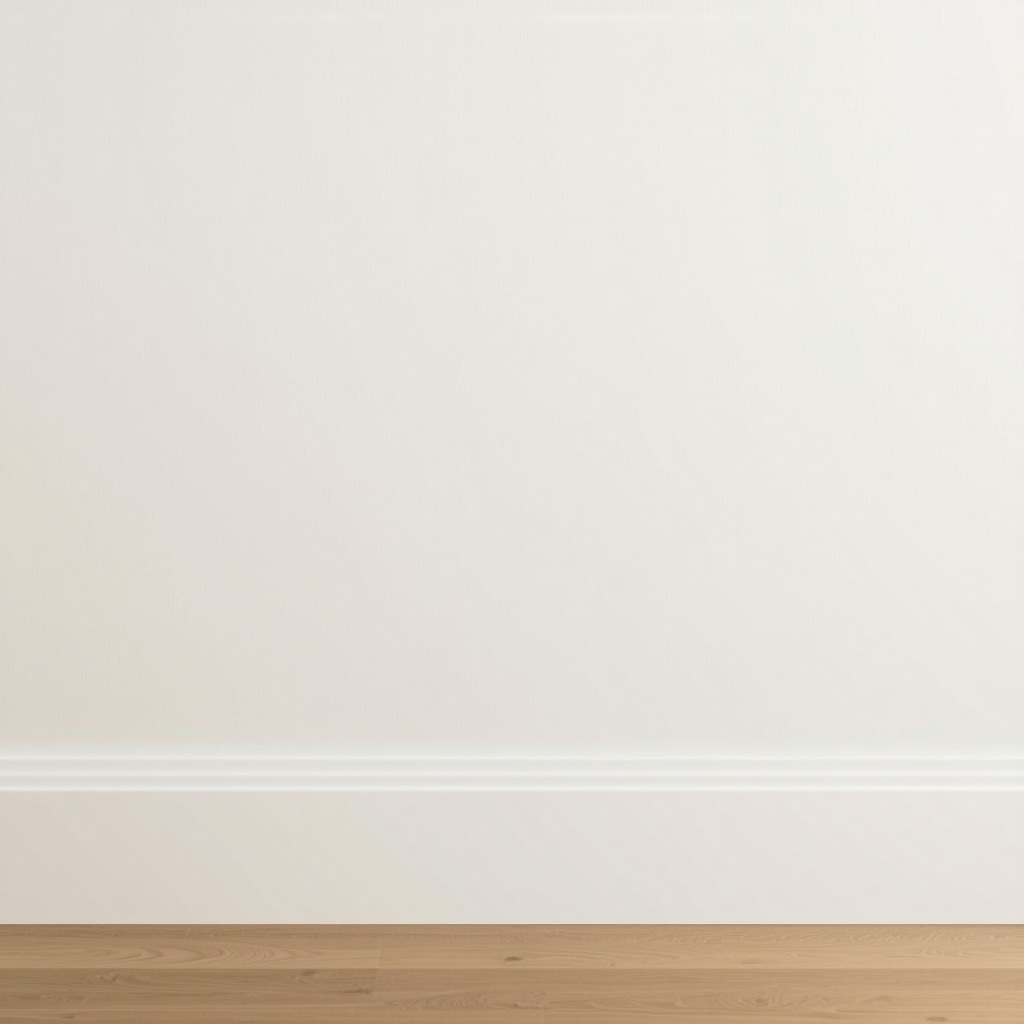Close-up image of baseboards painted with high gloss white paint, showing smooth finish and painter's tape along edges